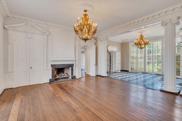 unfurnished living room featuring a notable chandelier, crown molding, and hardwood / wood-style floors