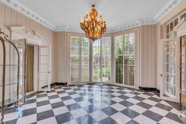 tiled spare room with a notable chandelier, french doors, crown molding, and plenty of natural light