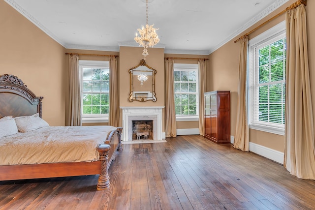 bedroom featuring crown molding, a fireplace, and hardwood / wood-style flooring