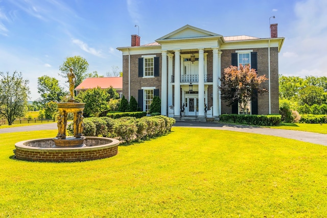 greek revival house with a front yard