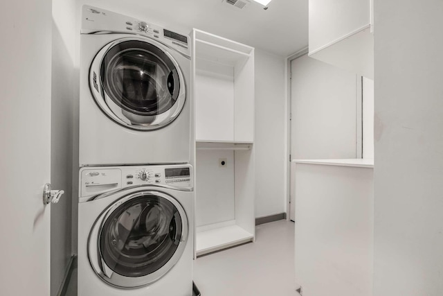 clothes washing area featuring stacked washer / dryer