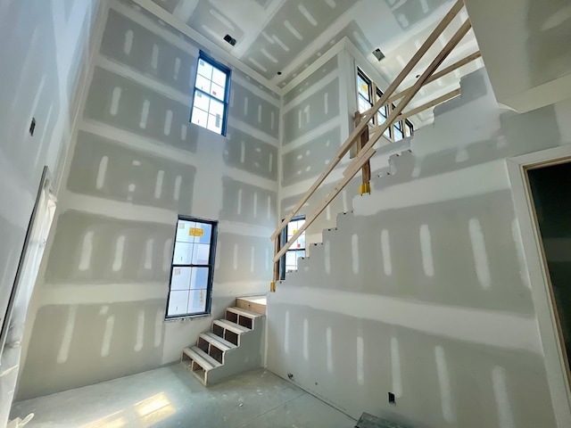 staircase featuring a high ceiling