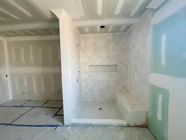 bathroom with tiled shower