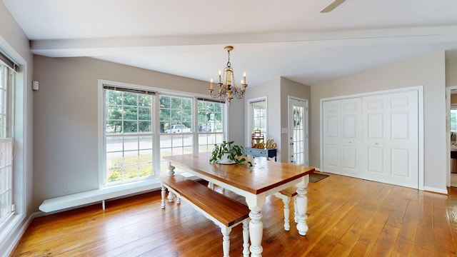 unfurnished dining area featuring a notable chandelier, beam ceiling, and light wood-type flooring