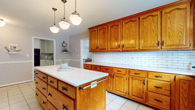 kitchen with a center island, light tile patterned floors, double oven, pendant lighting, and backsplash