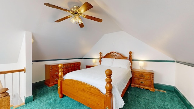 bedroom with ceiling fan, vaulted ceiling, and dark colored carpet