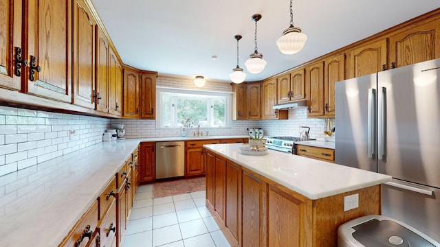 kitchen with tasteful backsplash, a center island, light tile patterned floors, pendant lighting, and stainless steel appliances