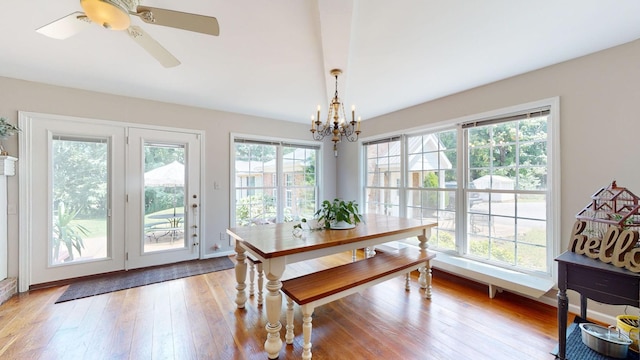 dining room with plenty of natural light, an inviting chandelier, and light wood-type flooring