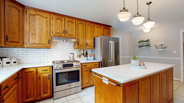 kitchen featuring light tile patterned floors, stainless steel appliances, tasteful backsplash, a kitchen island, and decorative light fixtures