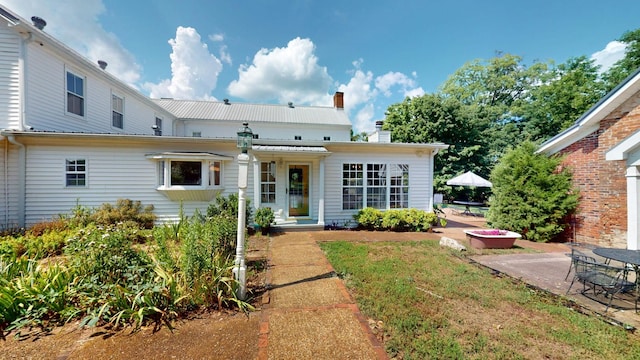 view of front facade with a front lawn and a patio area