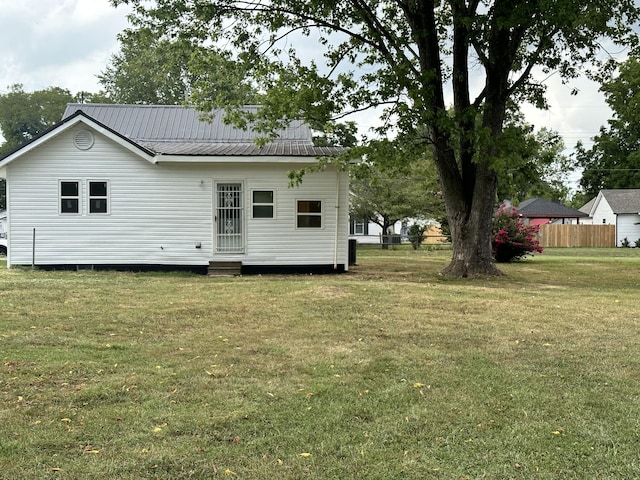 back of house with a lawn