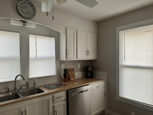 kitchen featuring white cabinets, a textured ceiling, sink, and dishwasher