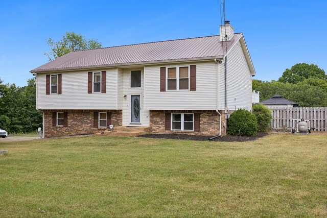 raised ranch featuring a front yard