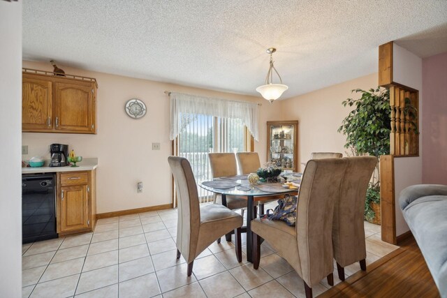 tiled dining space featuring a textured ceiling