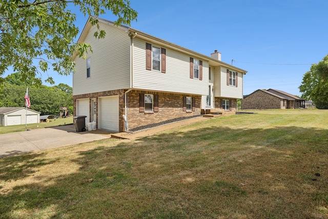 bi-level home featuring a garage and a front lawn