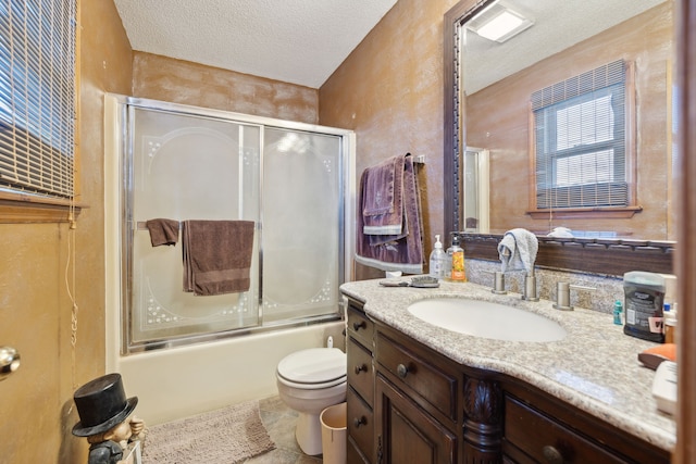 full bathroom with combined bath / shower with glass door, toilet, vanity, and a textured ceiling