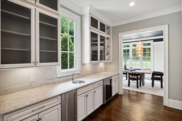 kitchen featuring wine cooler, sink, and a wealth of natural light