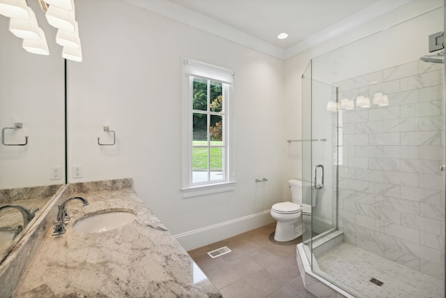 bathroom featuring tile patterned floors, toilet, a shower with shower door, crown molding, and vanity