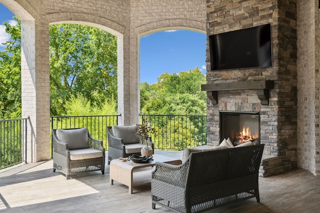 view of patio with an outdoor living space with a fireplace