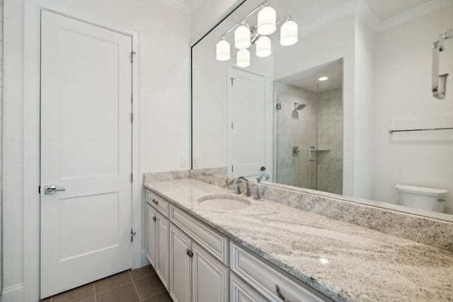 bathroom featuring toilet, tile patterned flooring, crown molding, vanity, and walk in shower