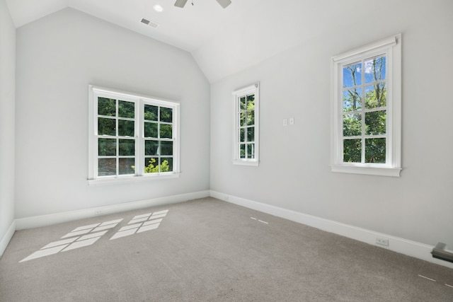 spare room featuring ceiling fan, light carpet, and lofted ceiling