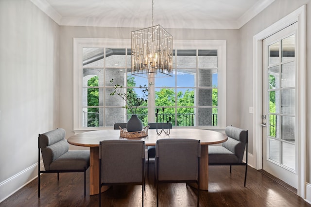 dining room with crown molding, a chandelier, and dark hardwood / wood-style floors