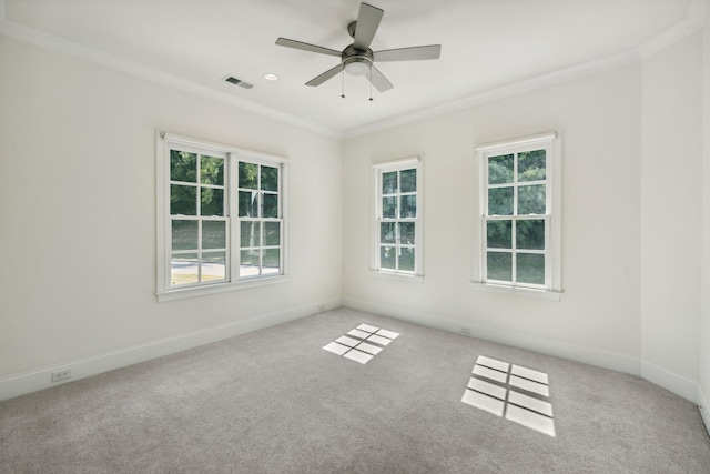 empty room featuring ornamental molding, light colored carpet, and ceiling fan