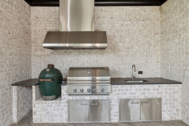 view of patio featuring an outdoor kitchen, sink, and area for grilling