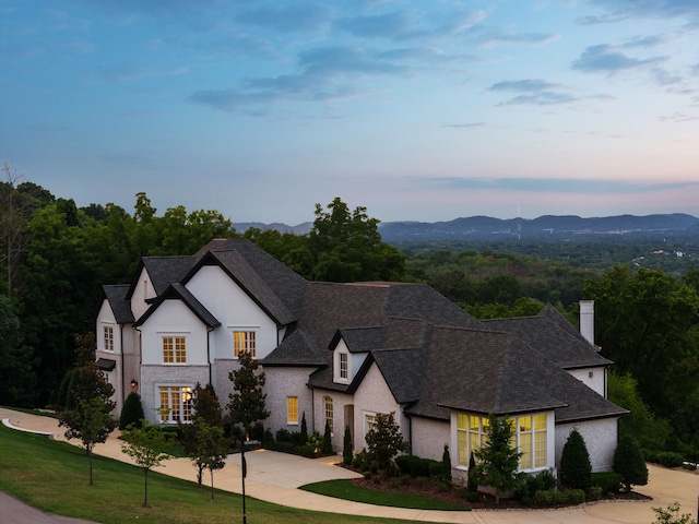 view of front facade with a yard and a mountain view