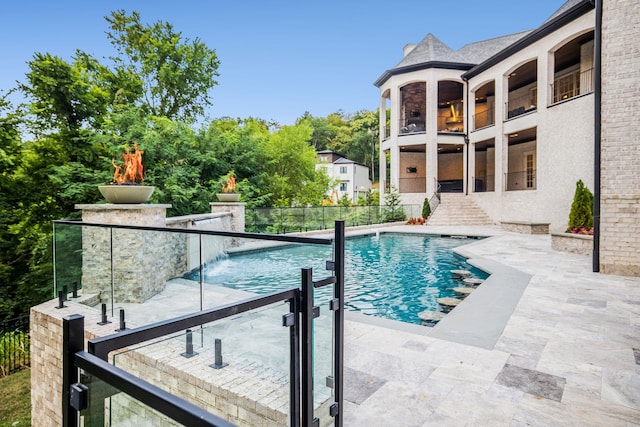 view of pool featuring a patio and pool water feature