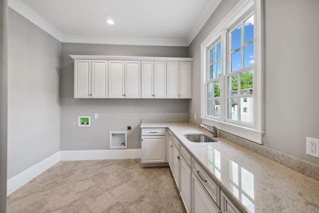 washroom with cabinets, washer hookup, ornamental molding, hookup for an electric dryer, and sink