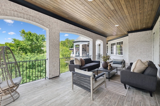 wooden terrace with an outdoor hangout area