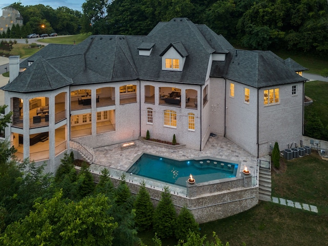 rear view of house featuring a balcony and a patio area