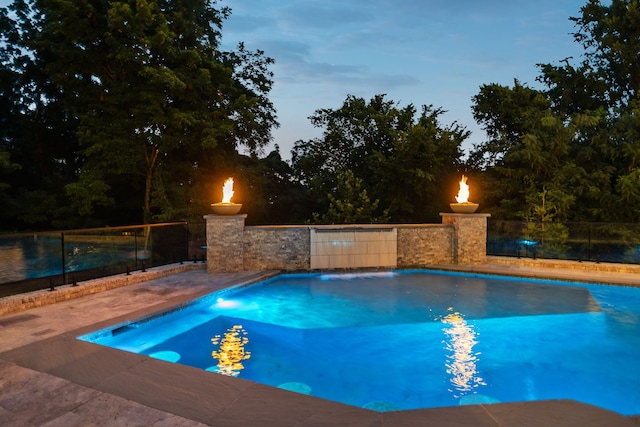 view of pool at dusk