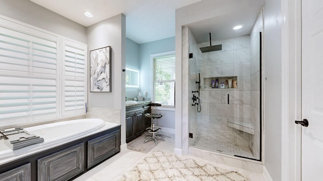 bathroom with vanity and separate shower and tub