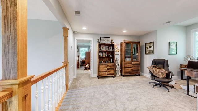 sitting room featuring light colored carpet