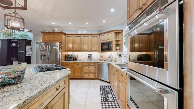 kitchen featuring pendant lighting, sink, backsplash, light tile patterned floors, and stainless steel appliances