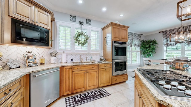 kitchen with pendant lighting, sink, crown molding, stainless steel appliances, and decorative backsplash