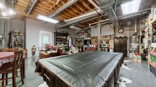 game room with pool table, water heater, and concrete floors