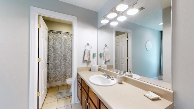 bathroom with vanity, tile patterned floors, toilet, and a shower with shower curtain