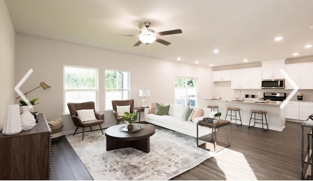 living room featuring plenty of natural light, dark wood-type flooring, and ceiling fan