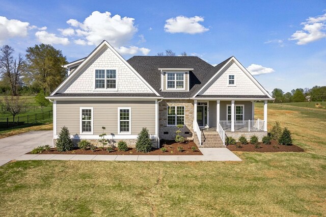 craftsman-style home featuring a porch and a front lawn