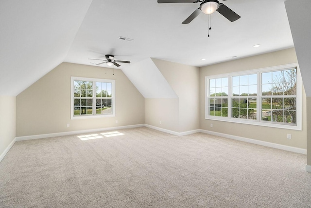 bonus room featuring ceiling fan, lofted ceiling, and light carpet