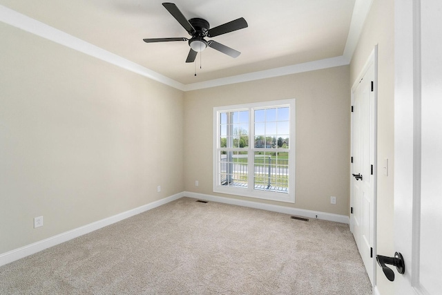 unfurnished room featuring ornamental molding, light colored carpet, and ceiling fan