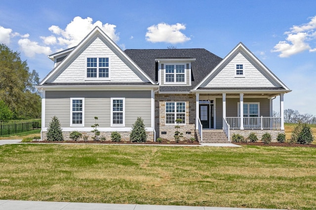 craftsman-style house featuring covered porch and a front yard