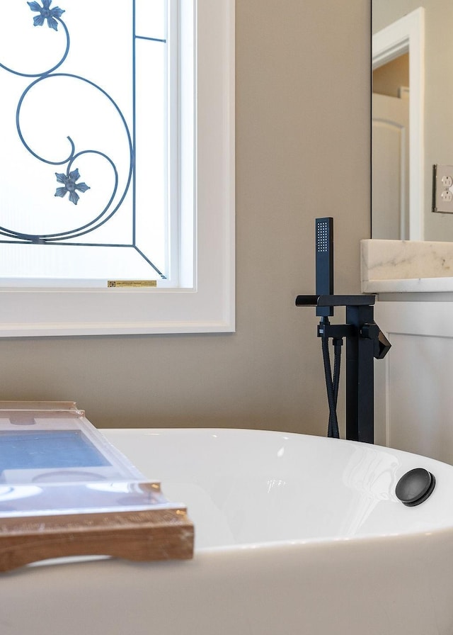 bathroom with a tub to relax in