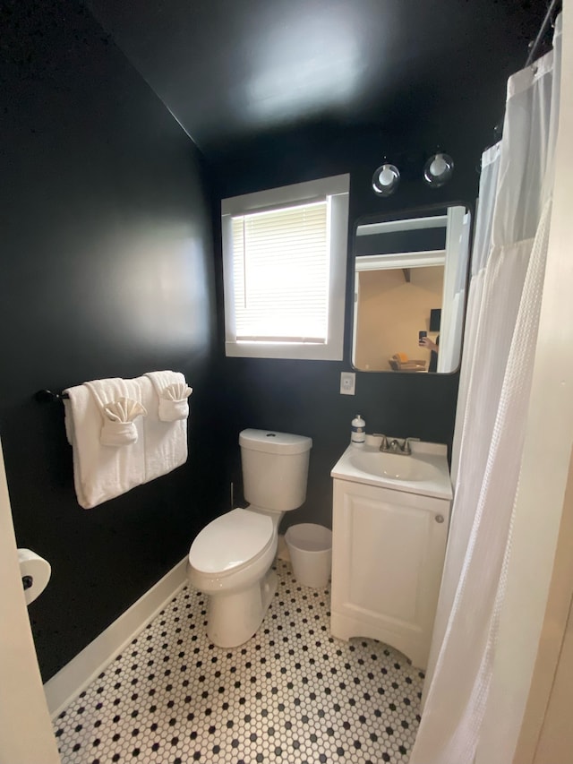 bathroom with vanity, toilet, and tile patterned flooring