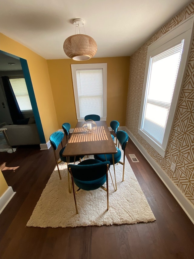 dining area with dark hardwood / wood-style floors