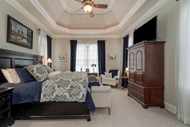 bedroom featuring crown molding, light carpet, ceiling fan, and a tray ceiling