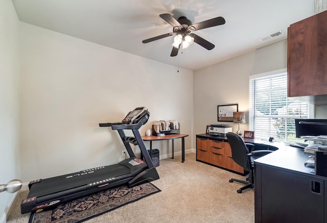 office space featuring light carpet and ceiling fan